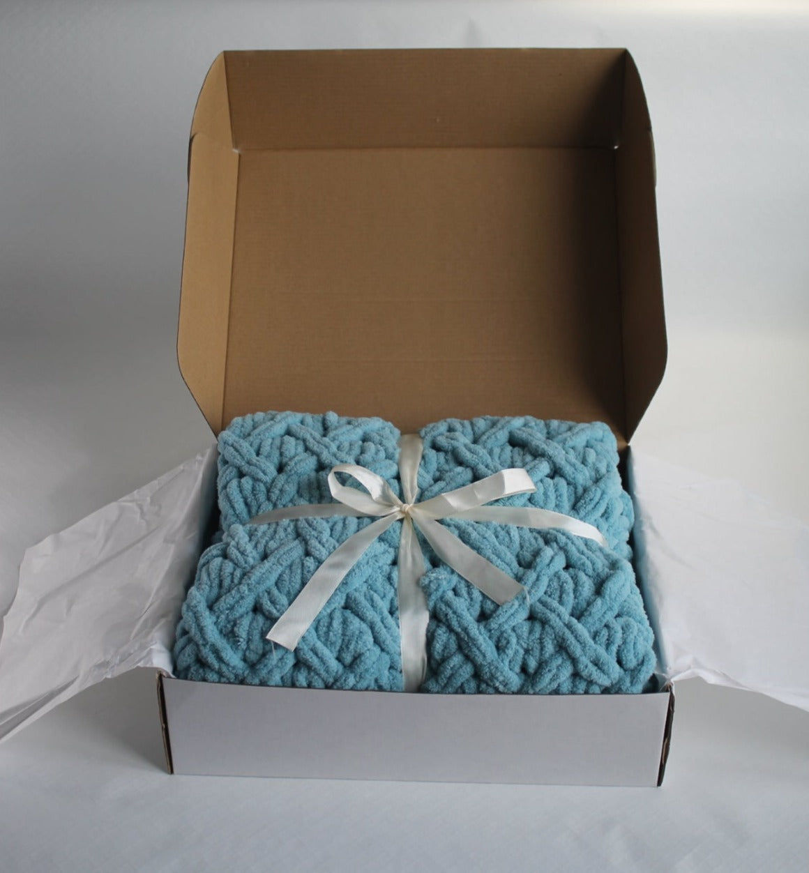 Baby plush blanket in the color of blue with shades of gray