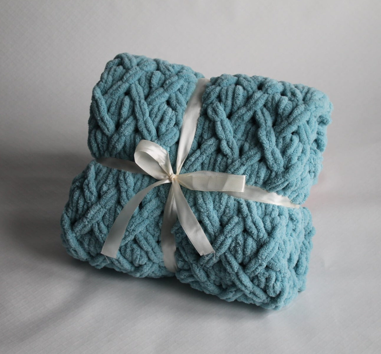 Baby plush blanket in the color of blue with shades of gray